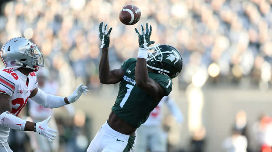 Football Catch In Action Wallpaper