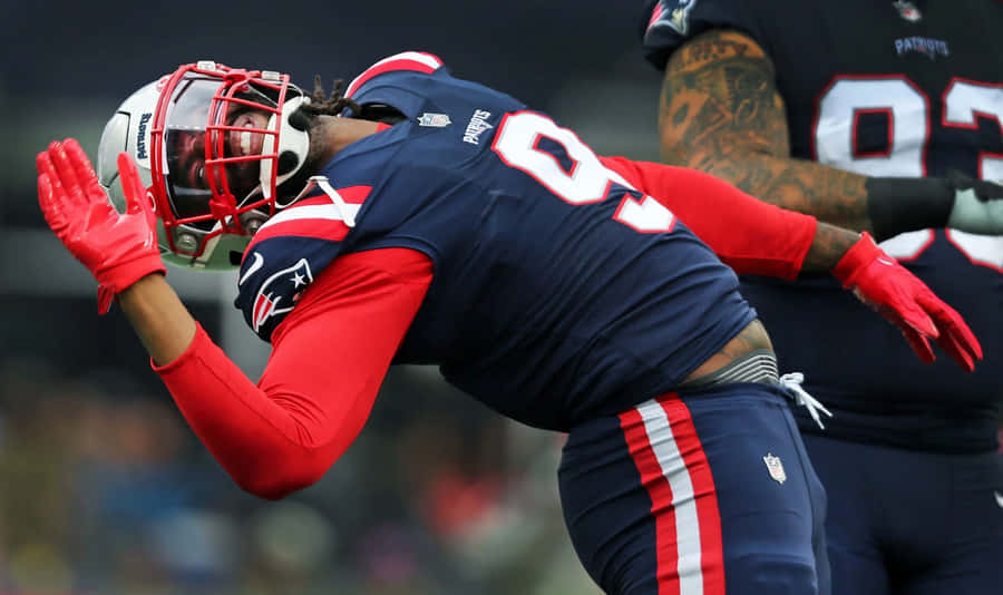 Football Player Blocking During Game Wallpaper