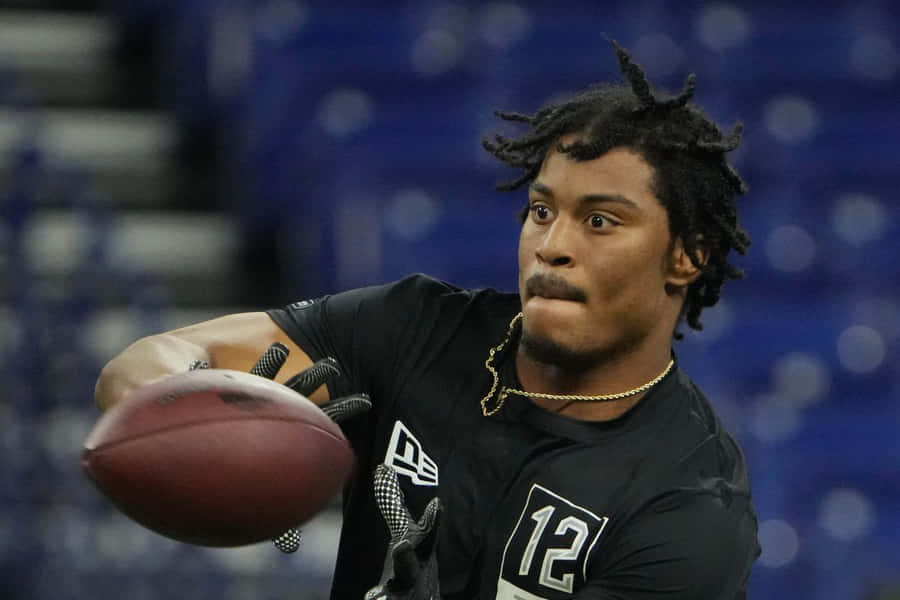 Football Player Catching Ball During Drill Wallpaper