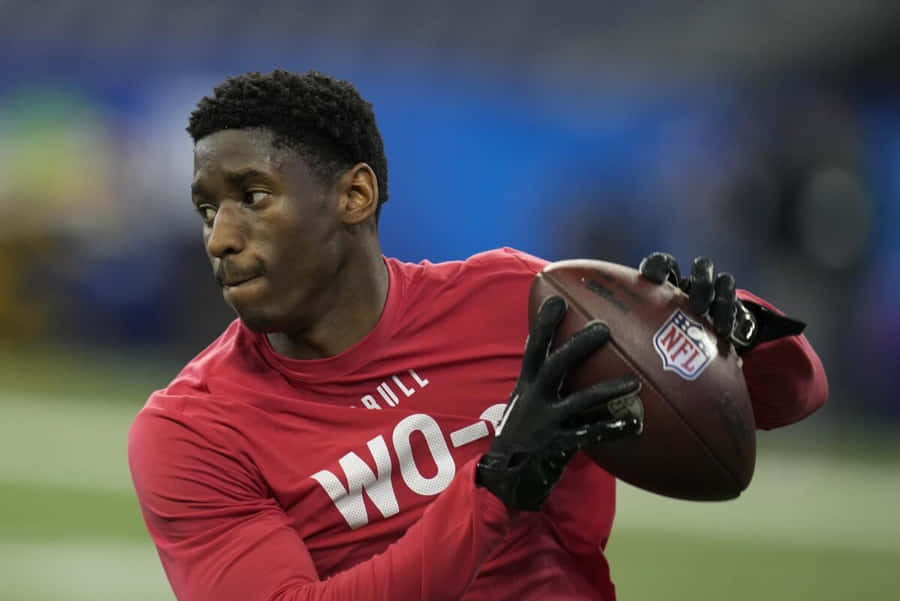 Football Player Catching Ball During Drill Wallpaper