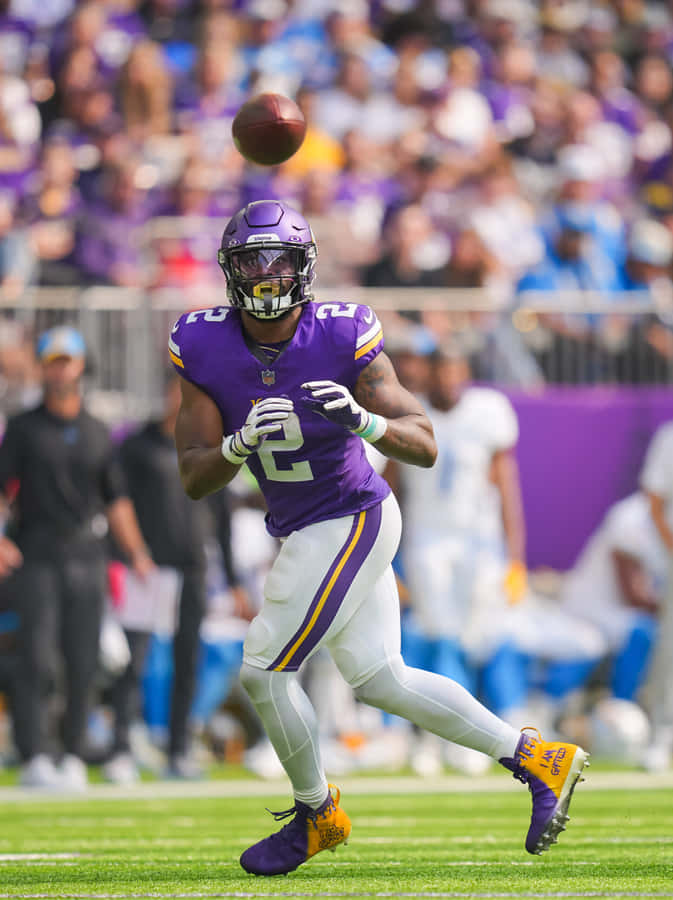 Football Player Catching Ball During Game Wallpaper