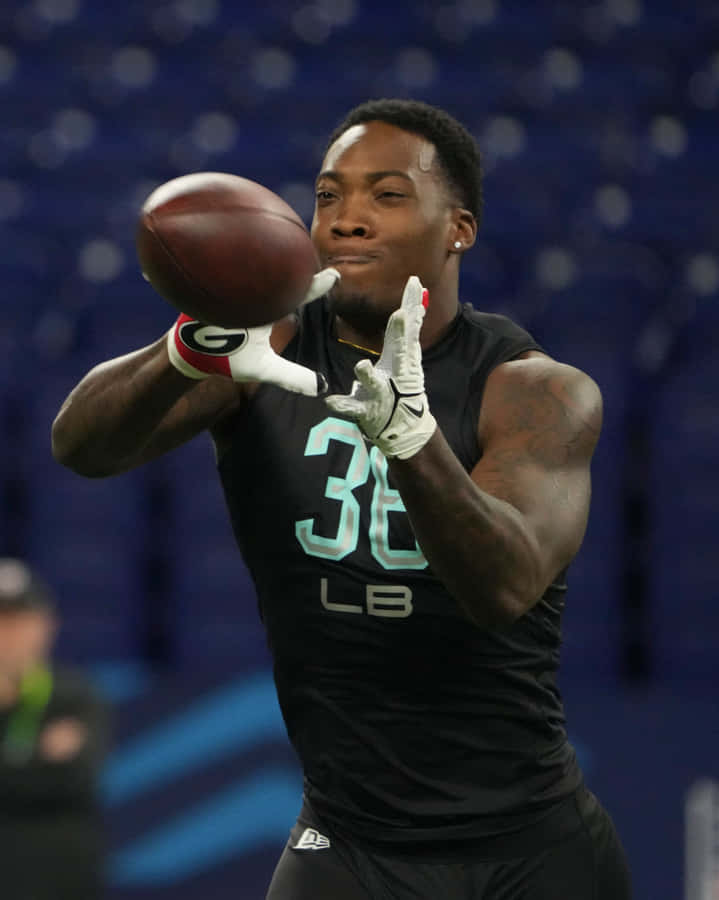 Football Player Catching Ball Wallpaper