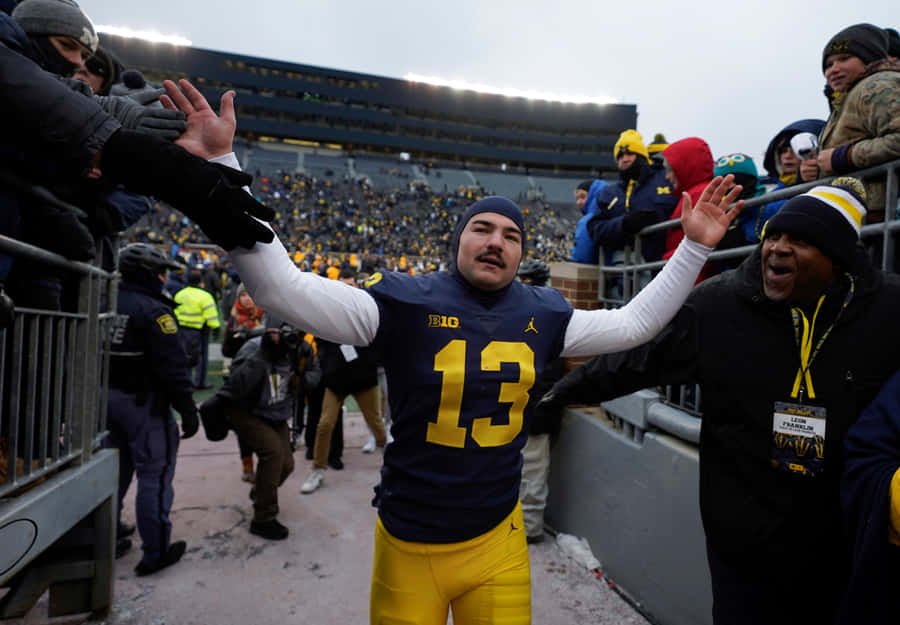 Football Player Celebratingwith Fans Wallpaper