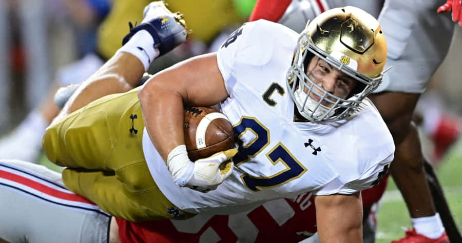 Football Player Diving Catch Wallpaper