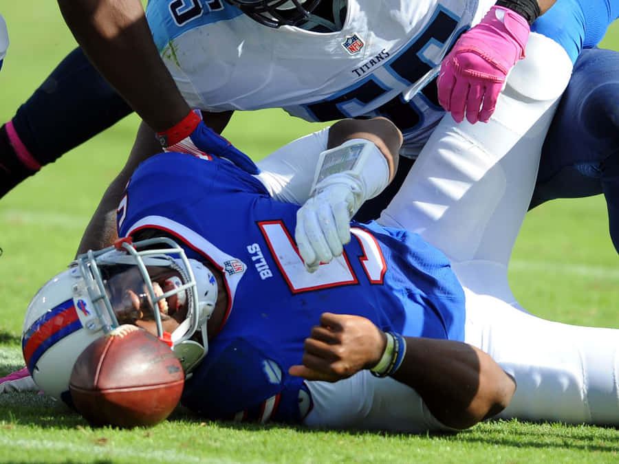 Football Player Down During Game Wallpaper