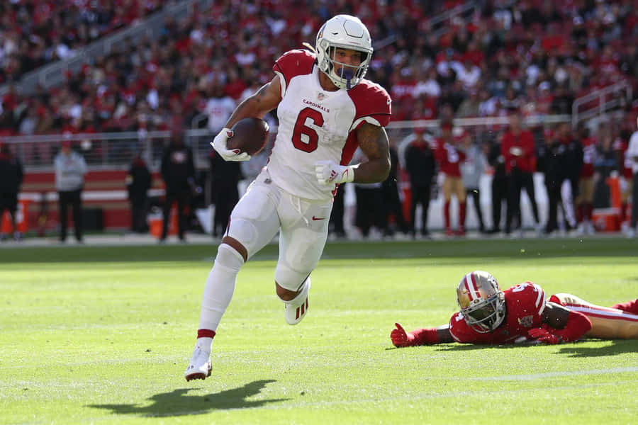 Football Player Evading Tackle.jpg Wallpaper