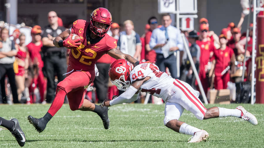 Football Player Evading Tackle Wallpaper