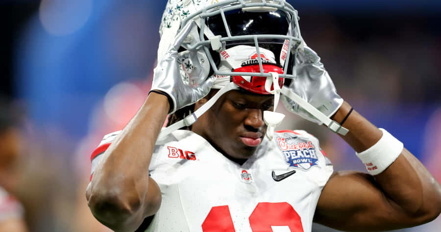 Football Player Flexing Muscles During Game Wallpaper