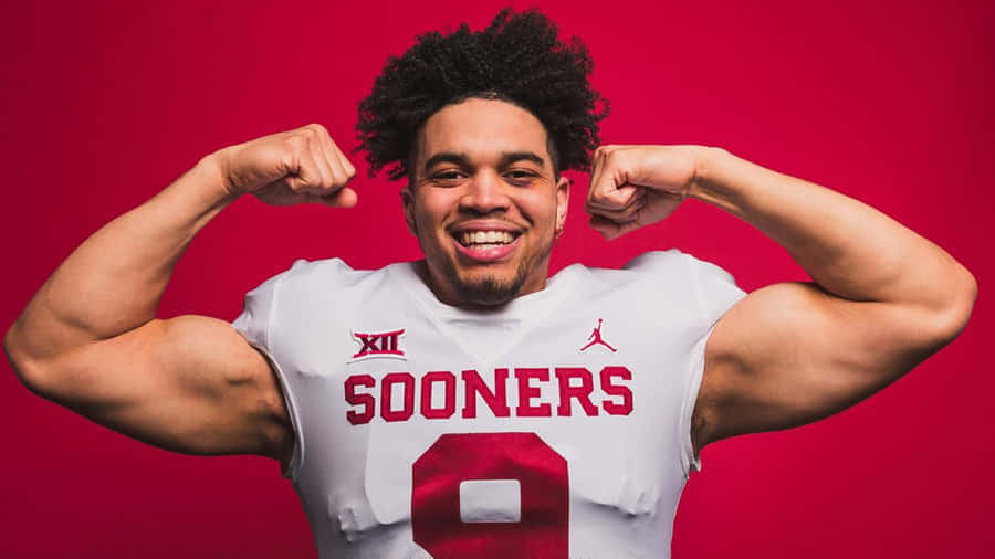 Football Player Flexing Muscles Wallpaper