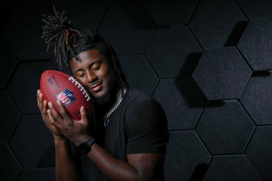Football_ Player_ Holding_ N F L_ Ball Wallpaper