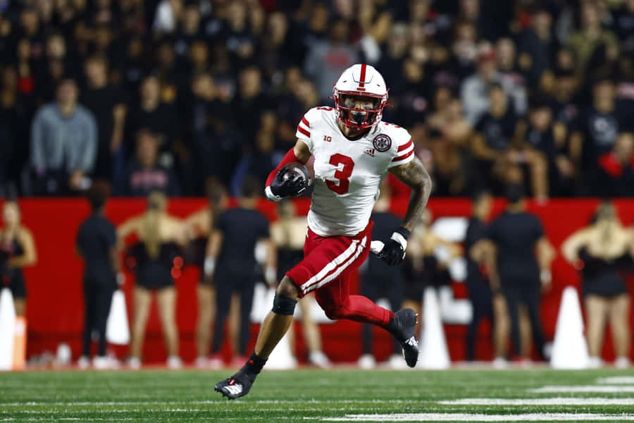 Football Player In Action During Game Wallpaper