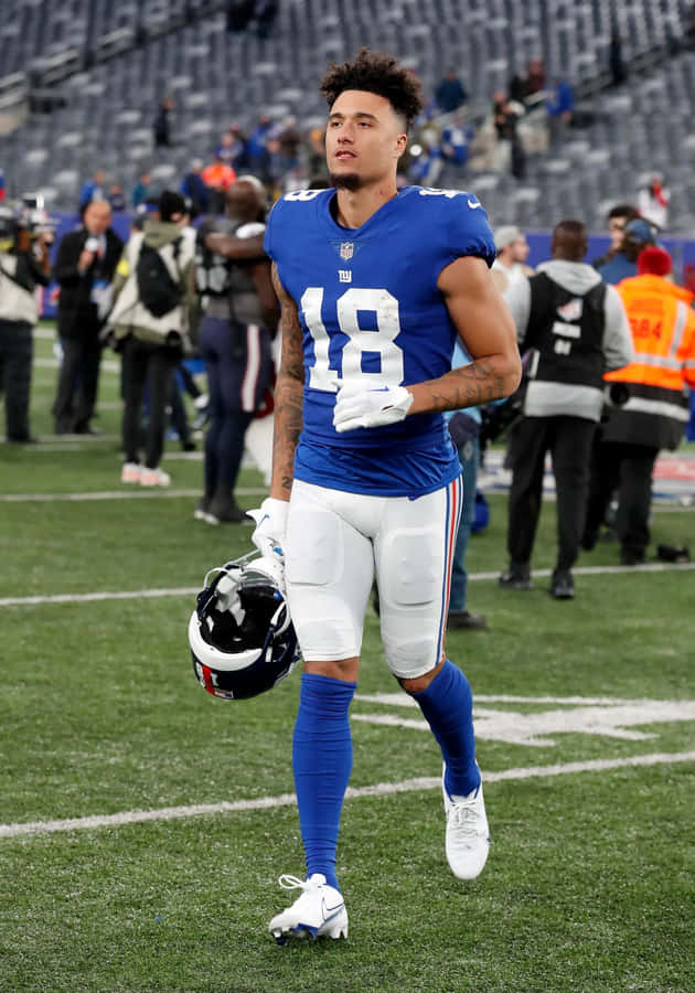 Football Player Isaiah Hodgins Walking Off Field Wallpaper