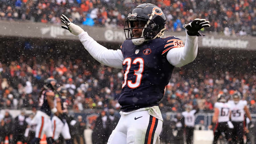 Football Player Snowy Game Celebration Wallpaper