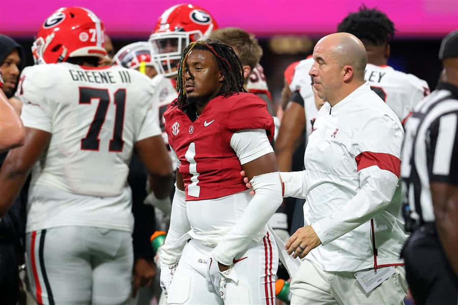 Football Player Walkingwith Coach Wallpaper