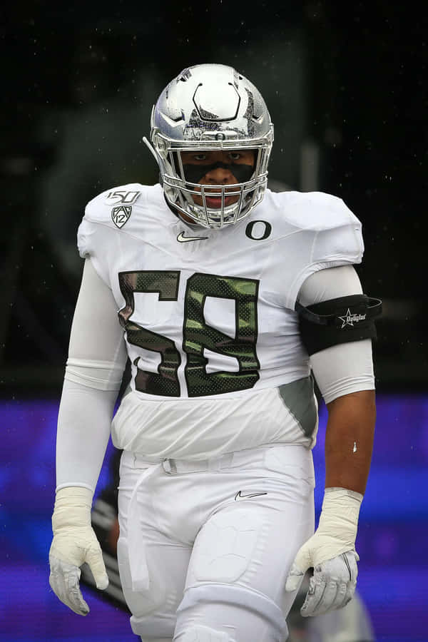 Football Playerin Action Rainy Game Wallpaper