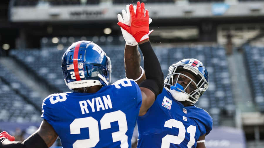 Football Players Celebrating On Field Wallpaper