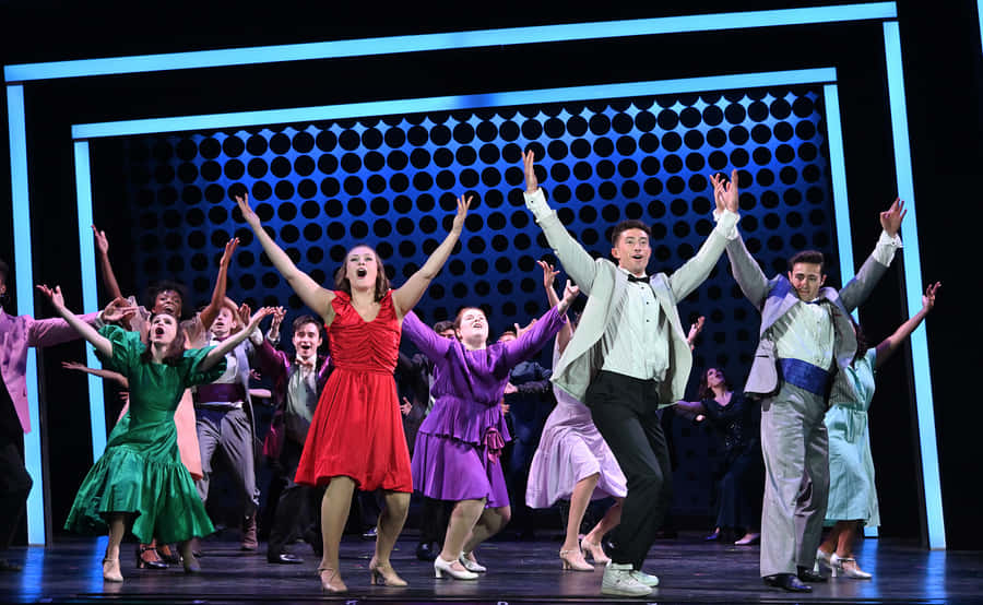 Footloose Musical Cast Dancing On Stage Wallpaper