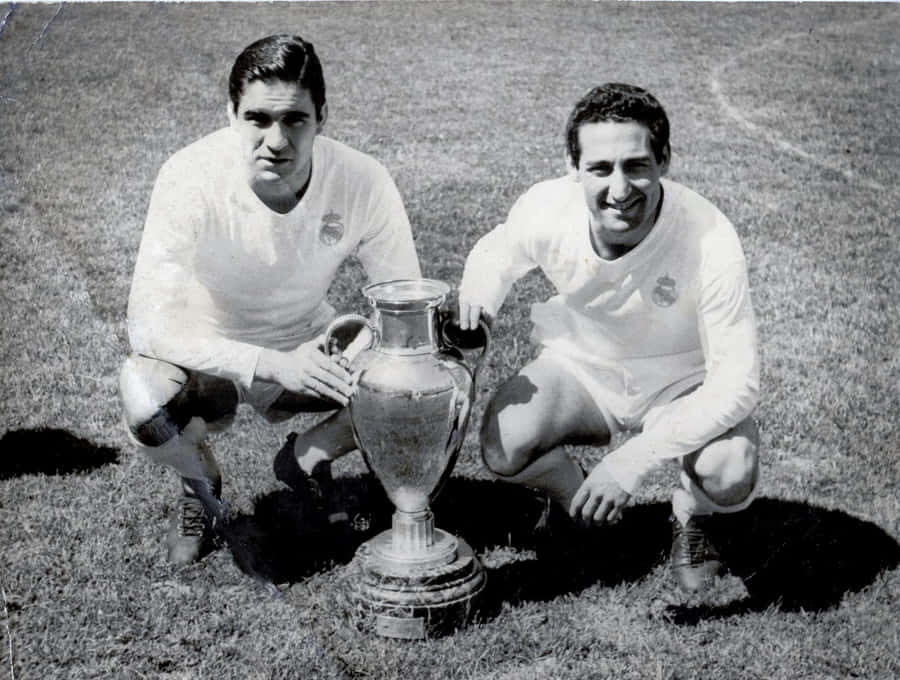Francisco Gento Posing Next To A Trophy Wallpaper