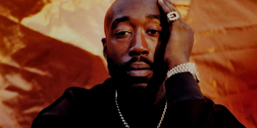 Freddie Gibbs Portrait Orange Backdrop Wallpaper