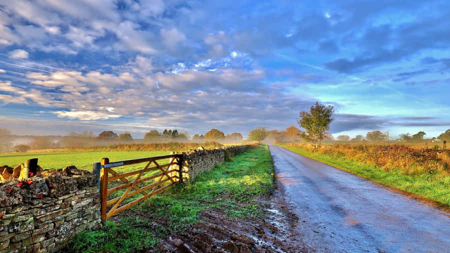 French Countryside Road Under Cloudy Sky Wallpaper