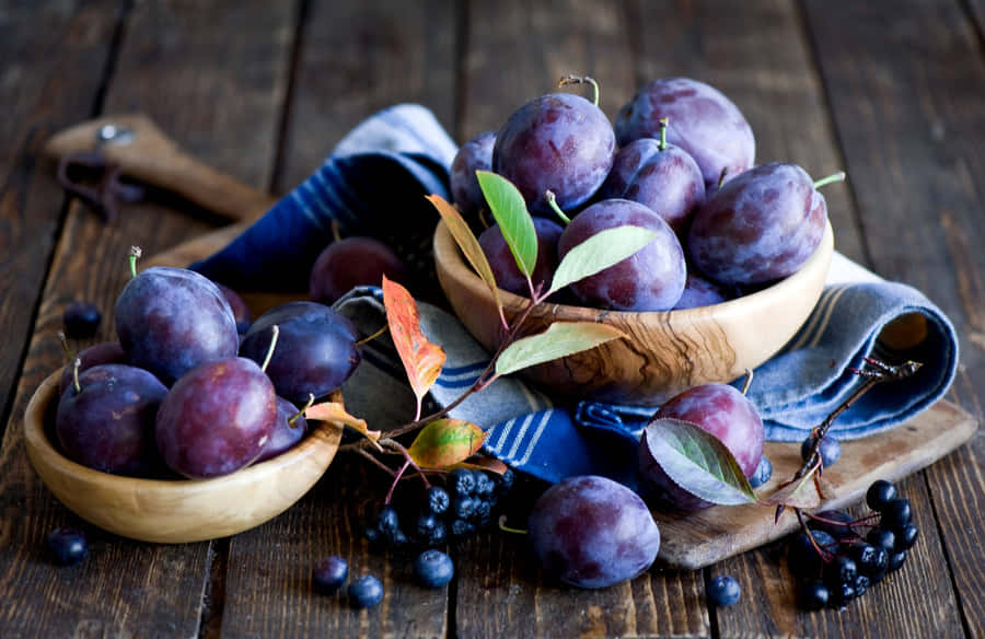 Fresh Italian Prune Plums And Blackberries In Wooden Bowls Wallpaper