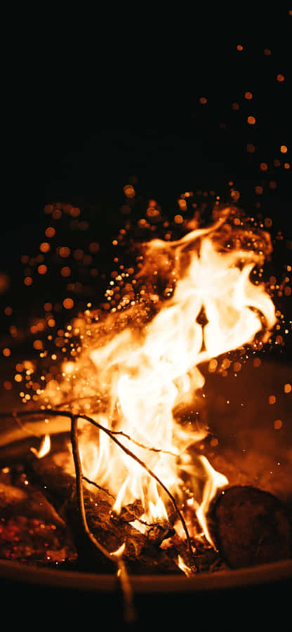 Friends Gathered Around A Cozy Bonfire On A Beautiful Autumn Evening Wallpaper