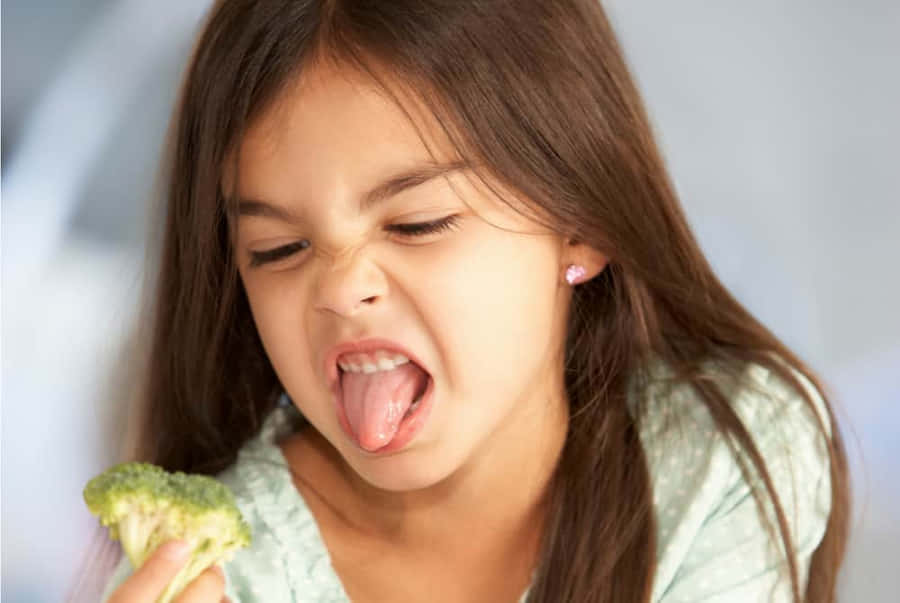 Girl Reluctant To Eat Broccoli Wallpaper