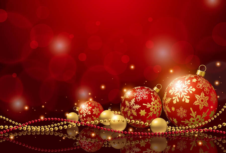 Gleaming Red Christmas Balls Hanging At Event Wallpaper