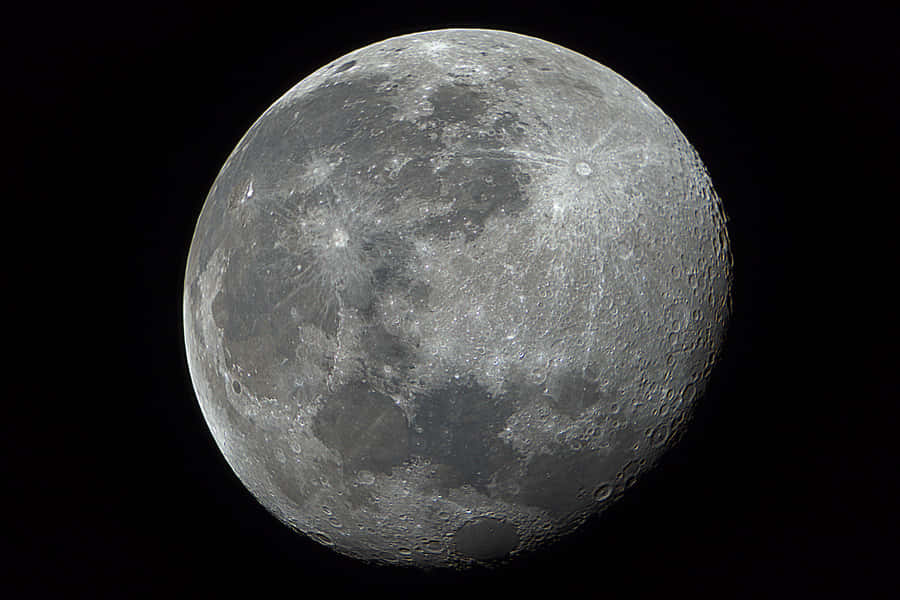 Gleaming Waning Gibbous Moon Illuminating The Night. Wallpaper