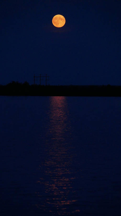 Glowing Full Moon In Sea Dark Mode Wallpaper