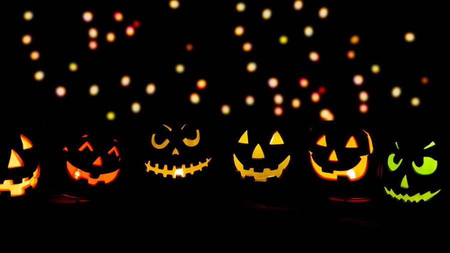 Glowing Halloween Pumpkins Bokeh Background Wallpaper