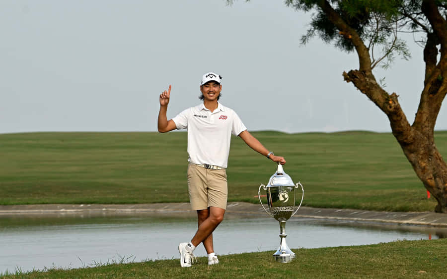 Golfer Celebrating Victory With Trophy Wallpaper