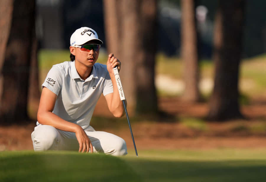 Golfer Evaluating Putton Green Wallpaper