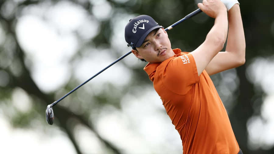 Golfer In Action Orange Shirt Wallpaper