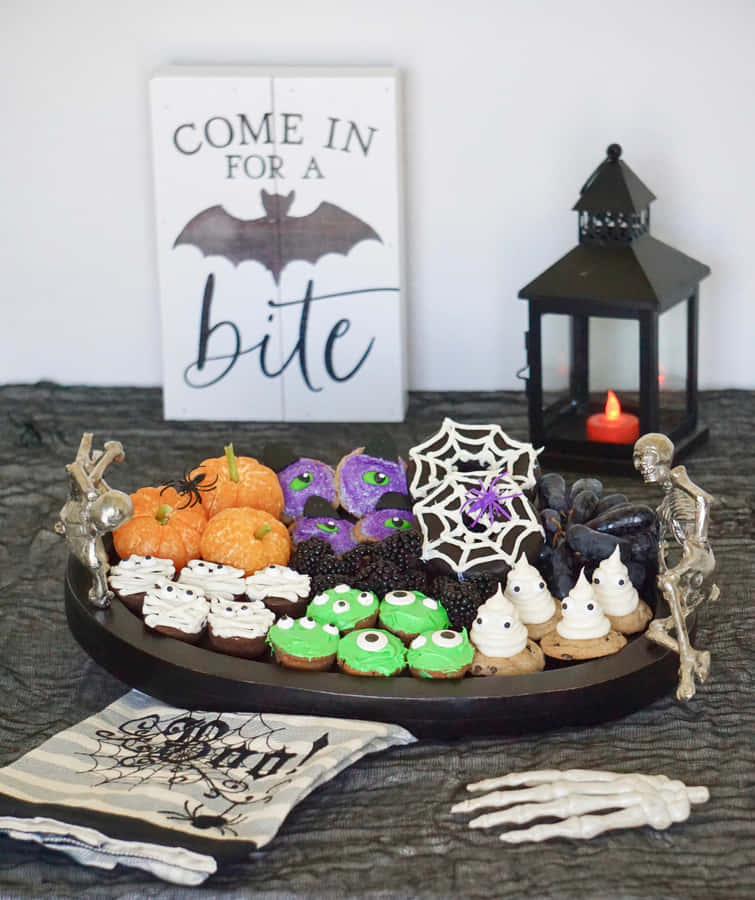 Halloween Treats Displaywith Spooky Decorations Wallpaper