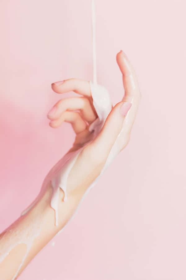 Hand Cream Pour Pink Background Wallpaper