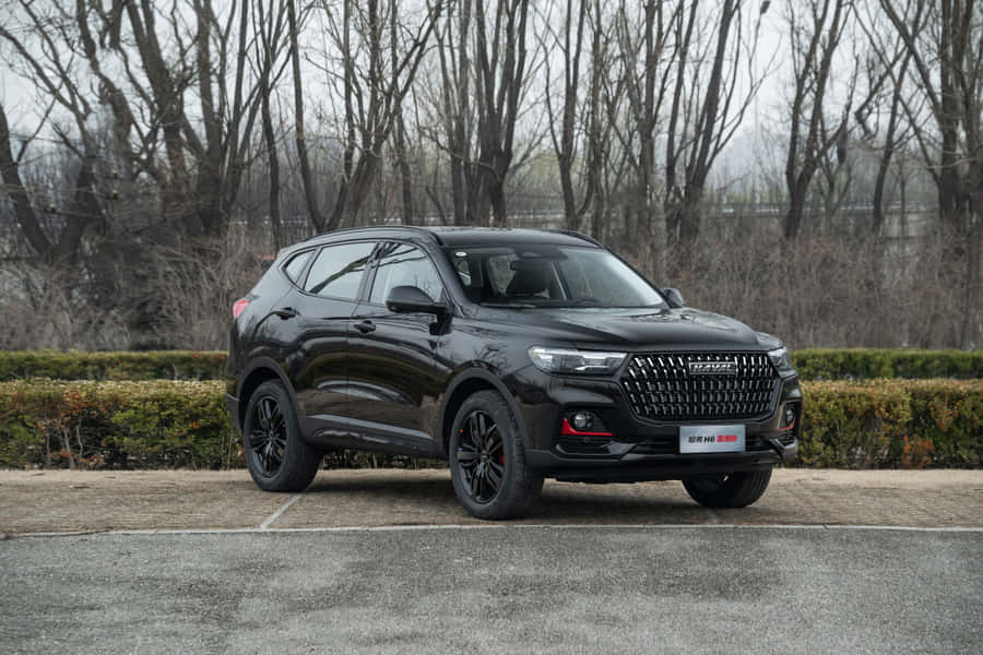 Haval's Stylish Suv Cruising Down The Road Wallpaper