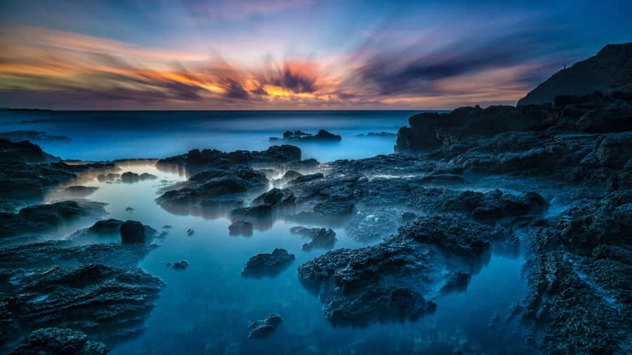 Hawaiian Sunset Over Rocky Shore Wallpaper