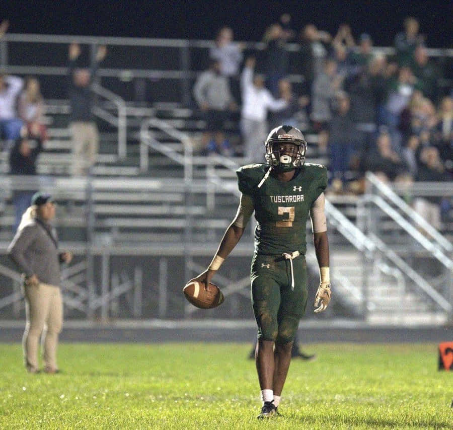 High School Football Player Night Game Wallpaper