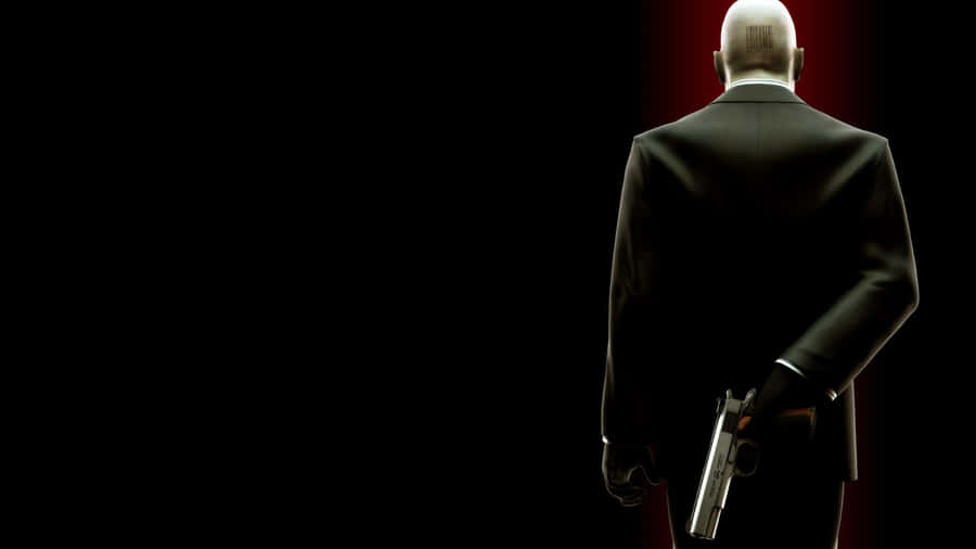 Hitman With Gun Behind Desktop Wallpaper