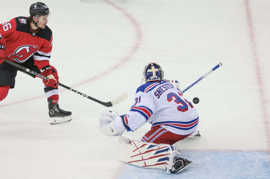 Hockey Player Shootingat Goalie Wallpaper