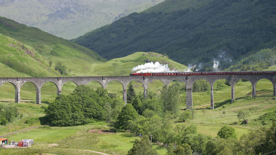 Hogwarts Express Chugging Through The Magical Landscape Wallpaper