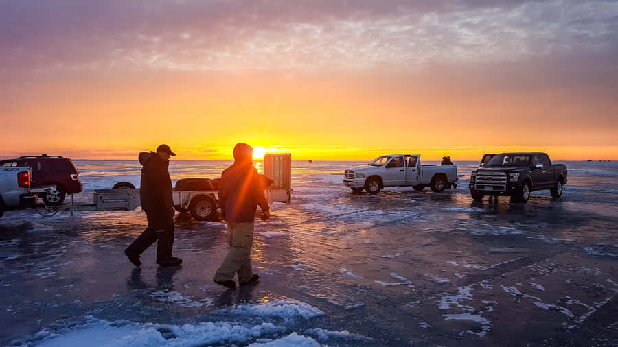 Ice Fishing Adventure On A Frozen Lake Wallpaper