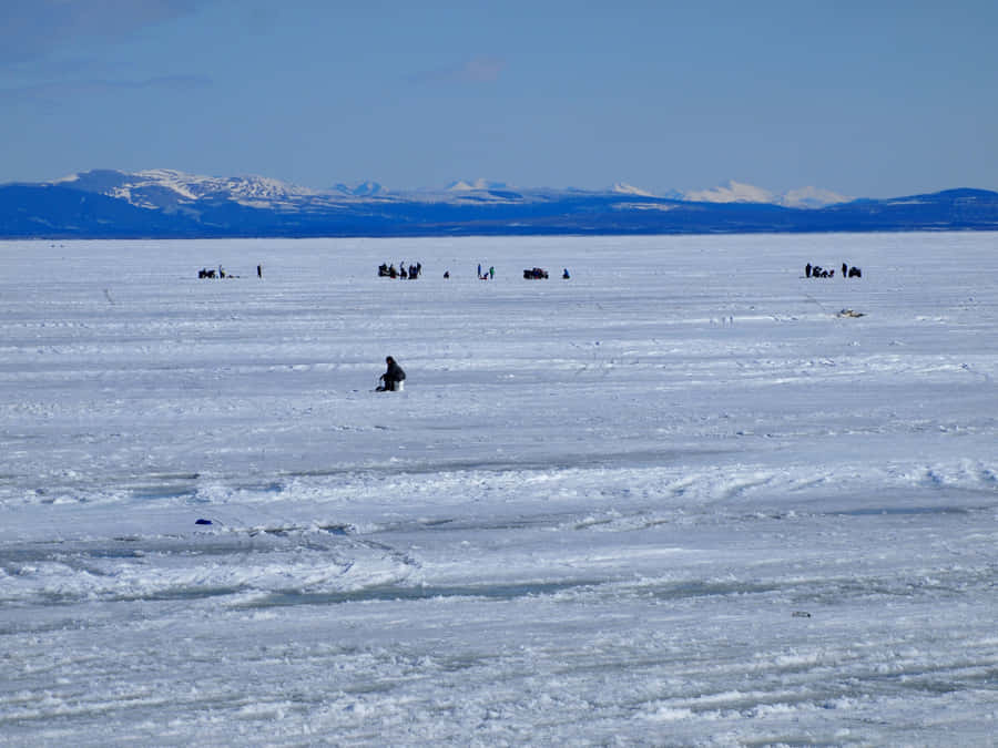 Ice Fishing On A Frozen Lake Wallpaper