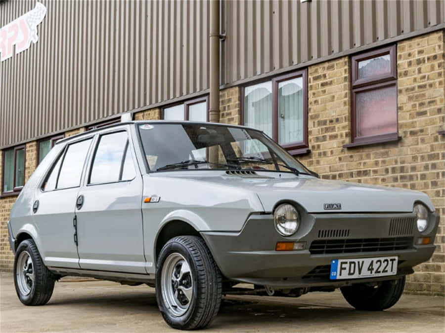 Iconic Fiat Ritmo Cruising Down The Road Wallpaper