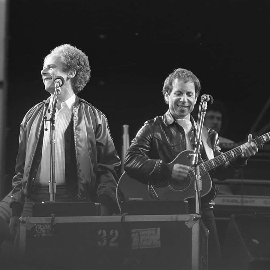 Iconic Folk Duo Performance Wallpaper