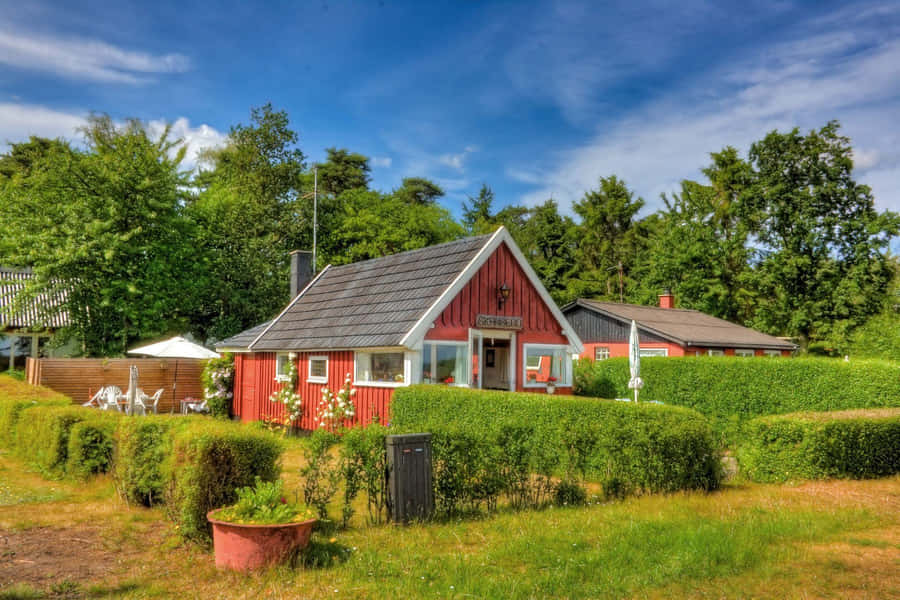 Idyllic Red Farmhouse Summer Setting Wallpaper