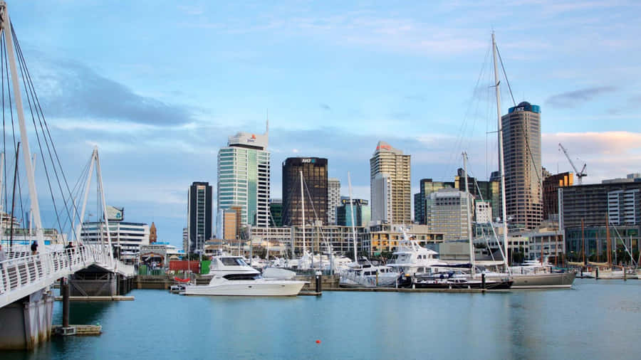 Illuminated Sky Tower Amidst Auckland City At Twilight Wallpaper