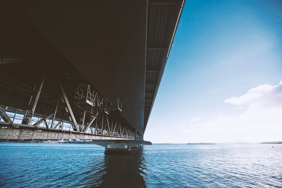 Image Concrete Bridge Spanning A Wide River Wallpaper
