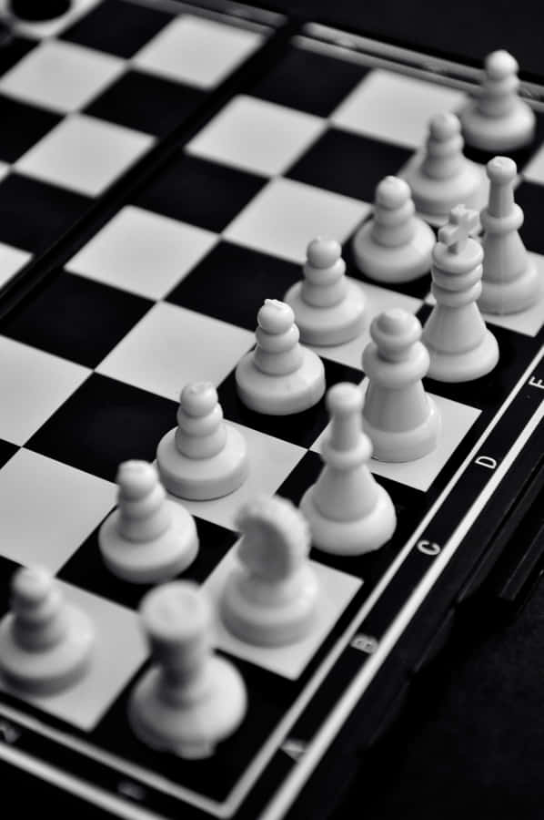 Intense Battle On A Black And White Chessboard Wallpaper
